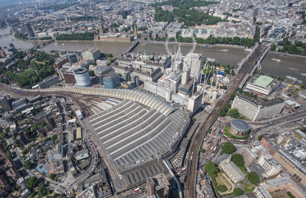 An aereial photograph showing London Waterloo, London Waterloo East and Charing Cross railway stations. In the distance, the Houses of Parliment can also be seen.